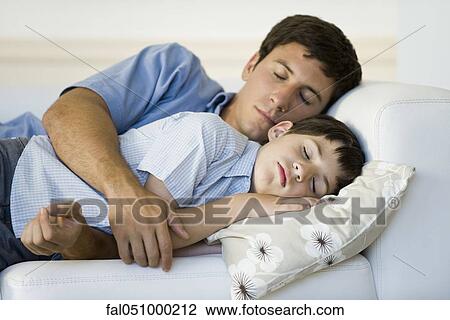 Father and son napping together on sofa View Large Photo Image Stock Image - Father and son napping together on sofa. Fotosearch