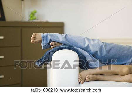 Father and son relaxing with feet up on sofa, cropped View Large Photo Image Stock Image - Father and son relaxing with feet up on sofa, cropped. Fotosearch