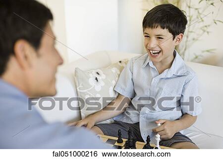Father and young son playing chess View Large Photo Image Stock Photograph - Father and young son playing chess. Fotosearch