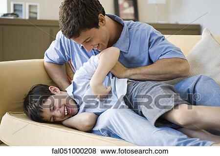 Father tickling young son View Large Photo Image Stock Photo - Father tickling young son. Fotosearch