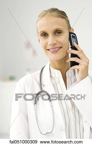 Female doctor on phone call, portrait View Large Photo Image Stock Photo - Female doctor on phone call, portrait. Fotosearch