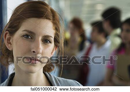 Female high school student, classmates in background View Large Photo Image Stock Image - Female high school student, classmates in background. Fotosearch
