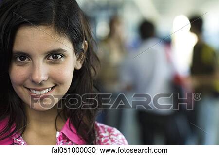 Stock Image - Female high school student smiling, portrait. Fotosearch