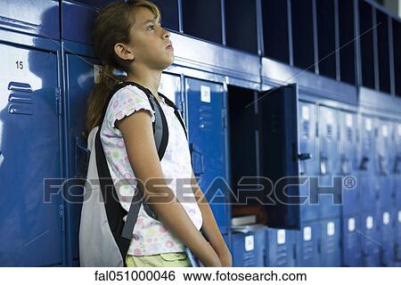 Female junior high student leaning against lockers contemplatively looking away View Large Photo Image Stock Photograph - Female junior high student leaning against lockers contemplatively looking away. Fotosearch