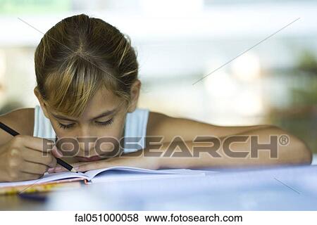 Female junior high student writing homework assignment View Large Photo Image Stock Photo - Female junior high student writing homework assignment. Fotosearch