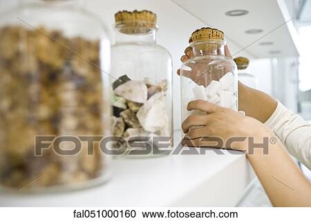 Getting down ingredient jars from shelf View Large Photo Image Stock Image - Getting down ingredient jars from shelf. Fotosearch