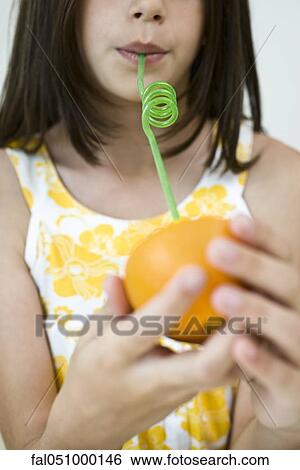 Girl drinking juice from orange half through straw View Large Photo Image Stock Photograph - Girl drinking juice from orange half through straw. Fotosearch