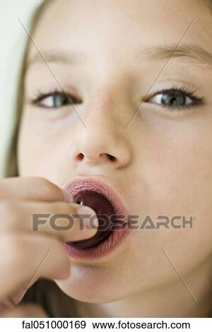 Girl eating cherry, close-up View Large Photo Image Stock Photo - Girl eating cherry, close-up. Fotosearch