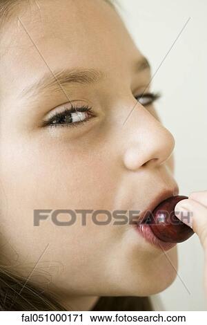 Girl eating cherry View Large Photo Image Stock Image - Girl eating cherry. Fotosearch