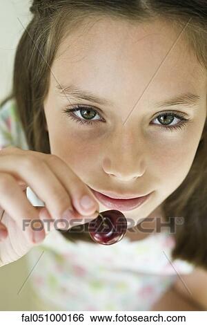 Girl eating cherry View Large Photo Image Stock Photograph - Girl eating cherry. Fotosearch