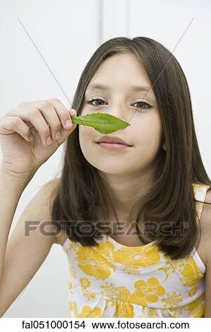 Girl enjoying fragrance of fresh herb View Large Photo Image Picture - Girl enjoying fragrance of fresh herb. Fotosearch