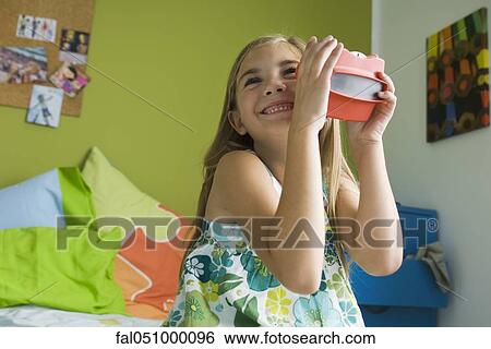 Girl playing with toy viewfinder View Large Photo Image Stock Photograph - Girl playing with toy viewfinder. Fotosearch