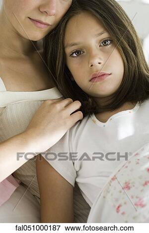 Girl with mother resting together under blanket View Large Photo Image Stock Photo - Girl with mother resting together under blanket. Fotosearch