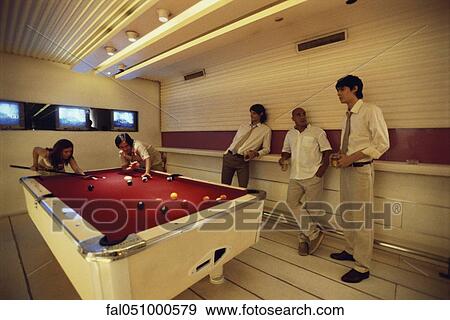 Group of friends playing pool in bar View Large Photo Image Stock Photo - Group of friends playing pool in bar. Fotosearch