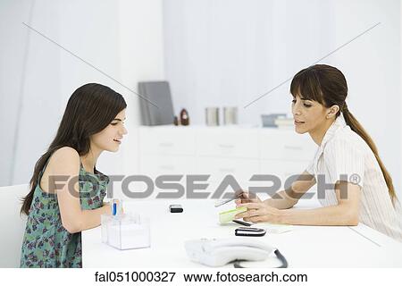 Gynecologist discussing birth control pills with teenage girl View Large Photo Image Stock Photo - Gynecologist discussing birth control pills with teenage girl. Fotosearch