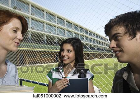 High school friends chatting together outside View Large Photo Image Stock Image - High school friends chatting together outside. Fotosearch