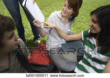 High school friends together, classmate showing assignment to others View Large Photo Image Stock Image - High school friends together, classmate showing assignment to others. Fotosearch
