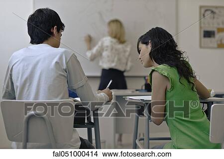 Picture - High school student copying classmate's assignment. Fotosearch