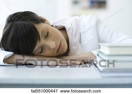 High school student napping with head on desk, stack of books in foreground View Large Photo Image Stock Photo - High school student napping with head on desk, stack of books in foreground. Fotosearch