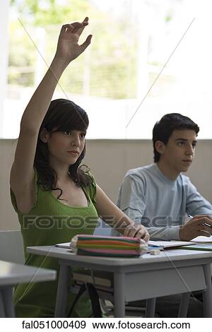 Stock Photo - High school student raising hand in class. Fotosearch