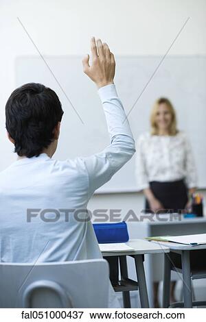 High school student raising hand in class View Large Photo Image Stock Photo - High school student raising hand in class. Fotosearch
