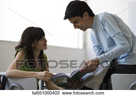 High school student showing book to classmate View Large Photo Image Stock Image - High school student showing book to classmate. Fotosearch