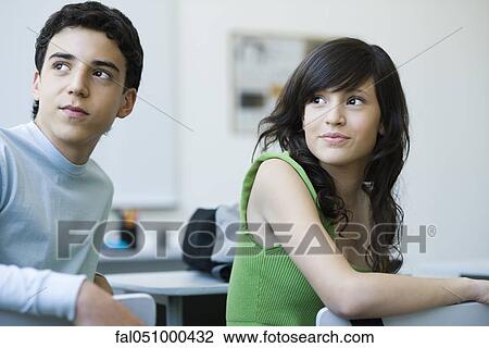 High school students in class, looking over shoulders with interest View Large Photo Image Stock Image - High school students in class, looking over shoulders with interest. Fotosearch