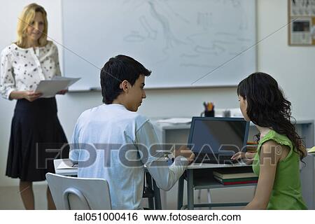 High school students using laptop computer in class View Large Photo Image Stock Photograph - High school students using laptop computer in class. Fotosearch