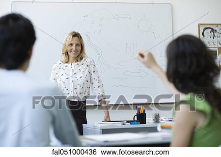 High school teacher standing in front of class, answering question View Large Photo Image Stock Photograph - High school teacher standing in front of class, answering question. Fotosearch