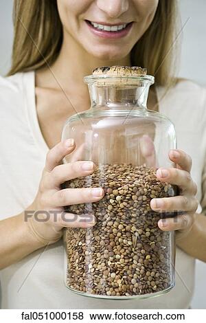 Holding jar of dried lentils View Large Photo Image Stock Photo - Holding jar of dried lentils. Fotosearch