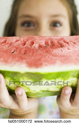 Holding up slice of watermelon View Large Photo Image Stock Image - Holding up slice of watermelon. Fotosearch