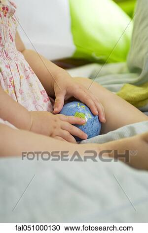 Infant holding toy globe, cropped View Large Photo Image Stock Image - Infant holding toy globe, cropped. Fotosearch