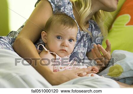 Infant in arms of mother View Large Photo Image Stock Image - Infant in arms of mother. Fotosearch