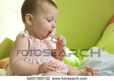 Stock Image - Infant with pacifier. Fotosearch