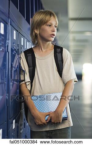 Junior high student leaning against locker in school corridor View Large Photo Image Picture - Junior high student leaning against locker in school corridor. Fotosearch