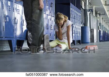 Junior high student sitting on floor crying, boy standing by watching View Large Photo Image Stock Photo - Junior high student sitting on floor crying, boy standing by watching. Fotosearch