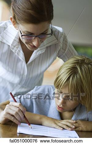 Junior high student watching at teacher corrects classwork View Large Photo Image Stock Photograph - Junior high student watching at teacher corrects classwork. Fotosearch
