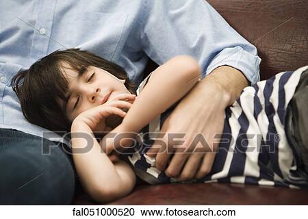 Little boy sleeping with head in father's lap View Large Photo Image Stock Image - Little boy sleeping with head in father's lap. Fotosearch