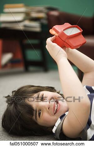 Little boy with toy viewfinder View Large Photo Image Stock Photo - Little boy with toy viewfinder. Fotosearch