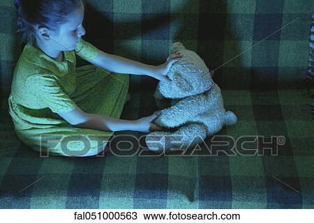 Little girl sitting on sofa with teddy bear View Large Photo Image Stock Image - Little girl sitting on sofa with teddy bear. Fotosearch