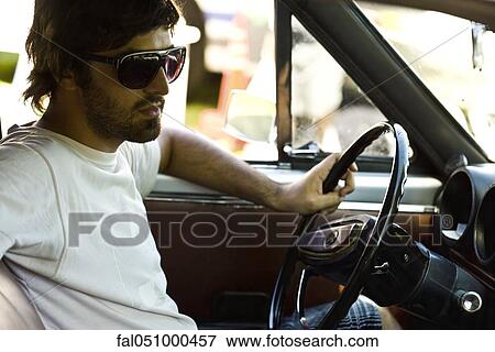 Macho young man driving View Large Photo Image Stock Photo - Macho young man driving. Fotosearch