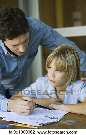 Male junior high student listening as teacher explains difficult assignment View Large Photo Image Stock Image - Male junior high student listening as teacher explains difficult assignment. Fotosearch