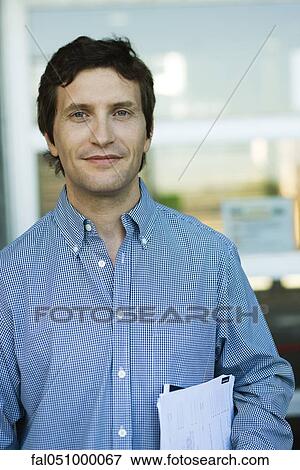Man carrying documents under arm, portrait View Large Photo Image Stock Photo - Man carrying documents under arm, portrait. Fotosearch