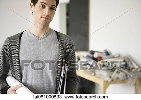 Stock Image - Man carrying rolled up blueprint under arm. Fotosearch