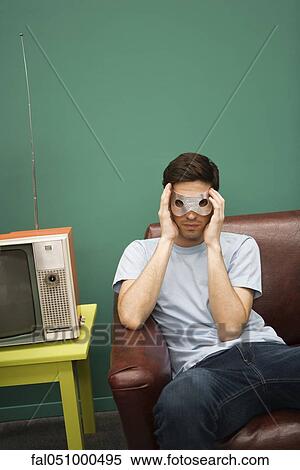 Stock Photography - Man concealing identity behind mask. Fotosearch