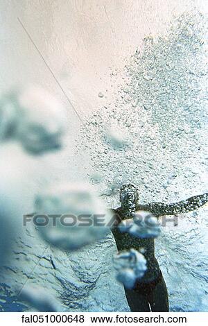 Man swimming underwater, low angle view View Large Photo Image Stock Photo - Man swimming underwater, low angle view. Fotosearch
