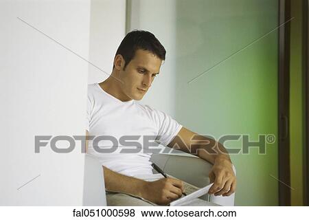 Man working crossword puzzle in newspaper View Large Photo Image Stock Photo - Man working crossword puzzle in newspaper. Fotosearch