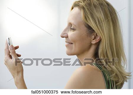 Mature woman text messaging, profile View Large Photo Image Stock Photography - Mature woman text messaging, profile. Fotosearch