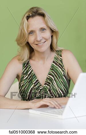 Mature woman with laptop computer, portrait View Large Photo Image Stock Photo - Mature woman with laptop computer, portrait. Fotosearch