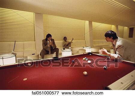Men hanging out in bar, one playing pool View Large Photo Image Stock Photo - Men hanging out in bar, one playing pool. Fotosearch